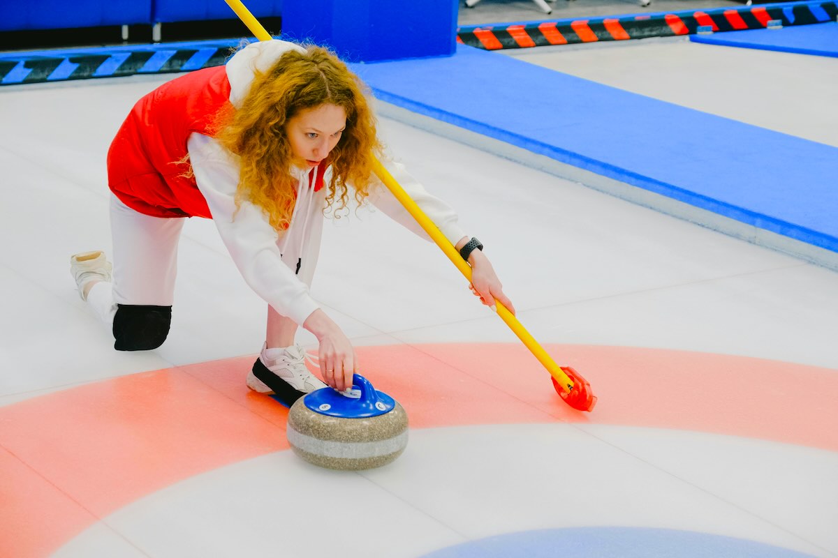 Curling stone and brooms