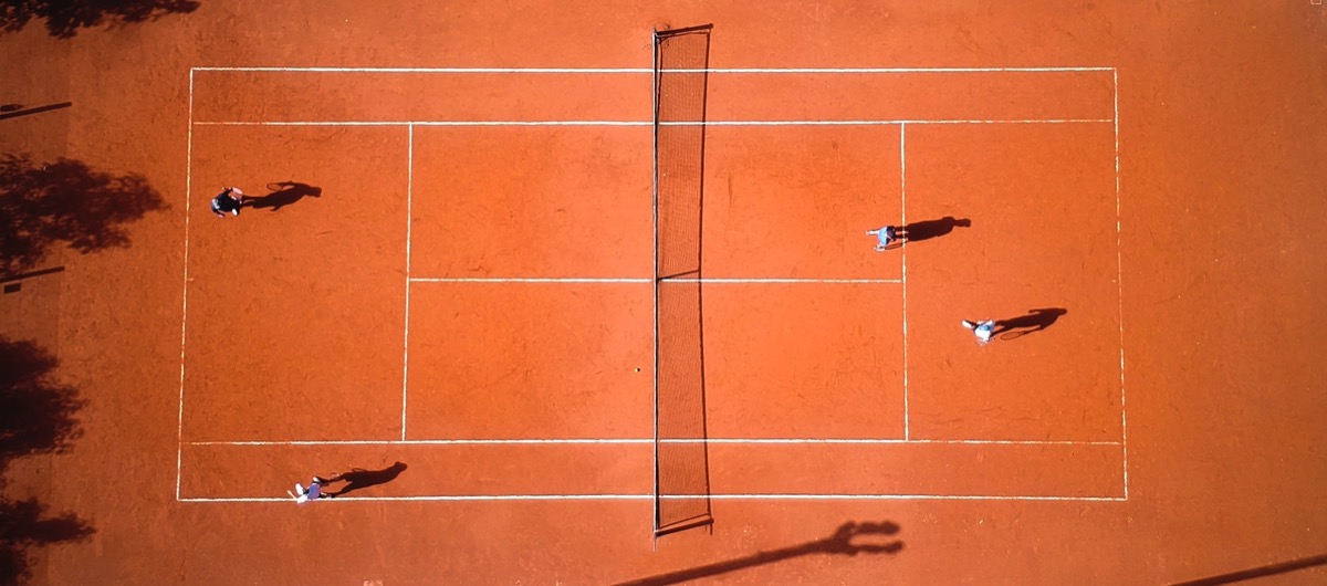 A game of tennis doubles, seen from above